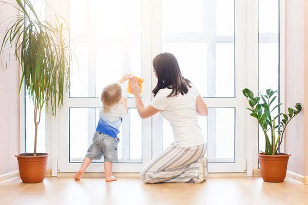 mother and son cleaning doors